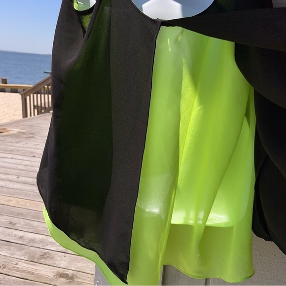 Black and chartreuse glossy top with adjustable straps, and a flowing open back. - Picture 4 of 5